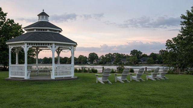 Gazebo and empty chairs on St. Michaels park grass at evening