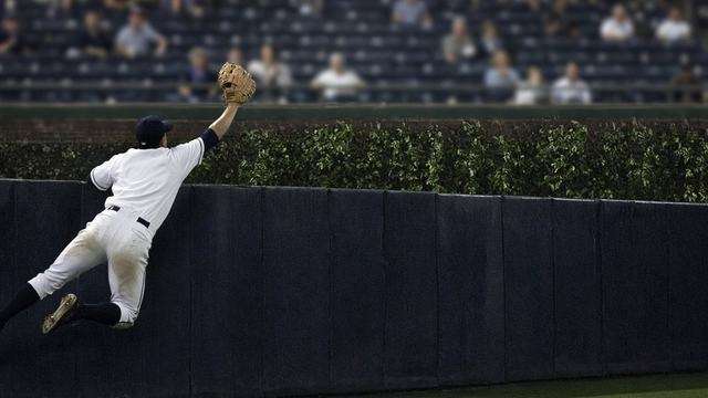 Coors Field outfield wall under night lights